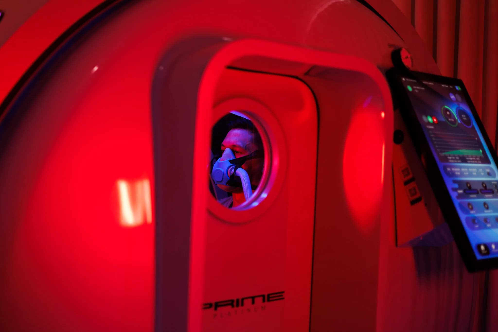 Customer viewed through the hyperbaric chamber porthole during treatment