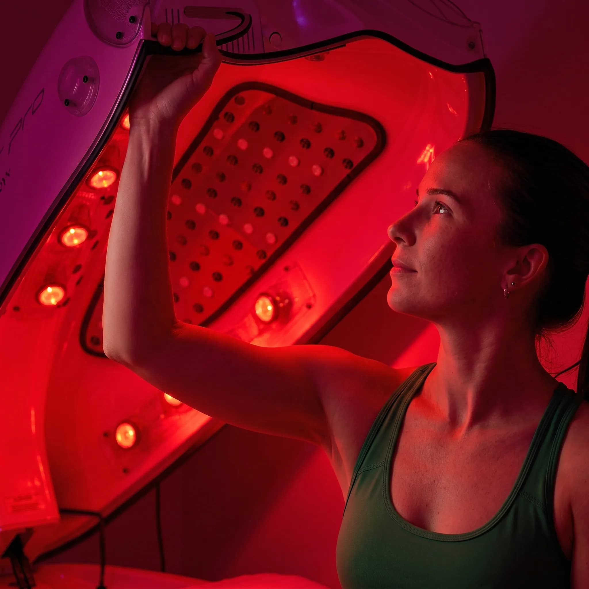 Woman using the infrared sauna cocoon controls