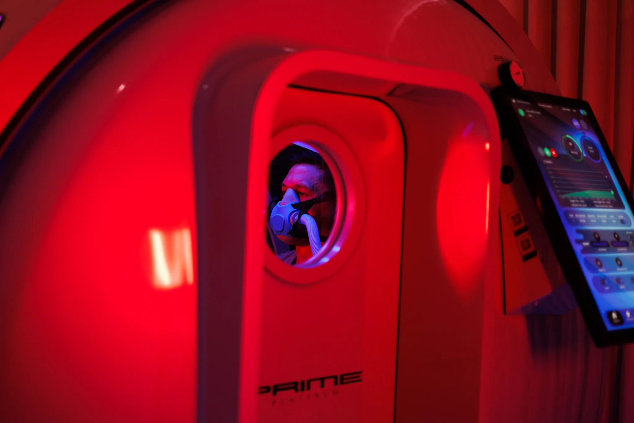 Customer viewed through the hyperbaric chamber porthole during treatment