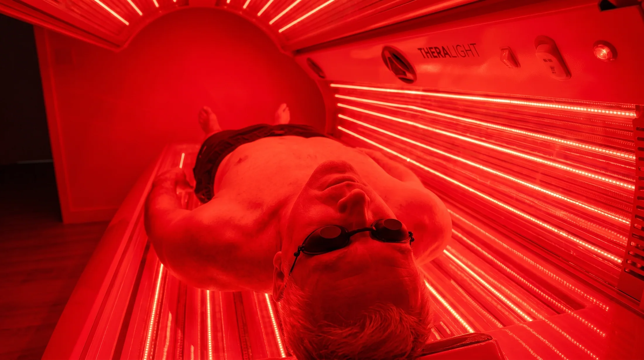 Man inside the TheraLight 360 red light therapy bed in Perth